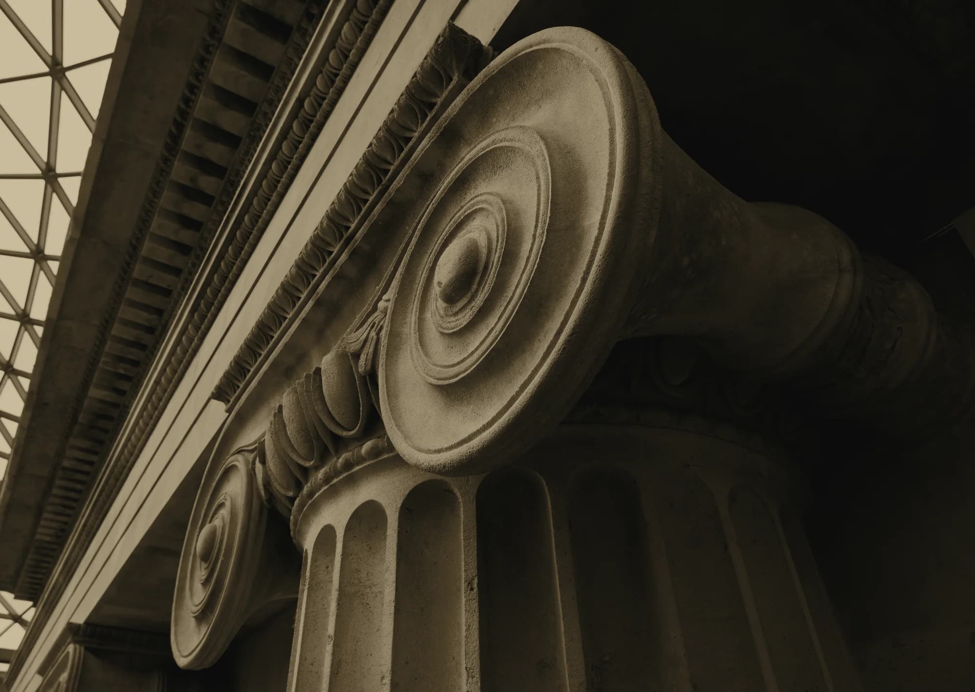 Stone Ionic capital under the glass grid of the British Museum Great Court